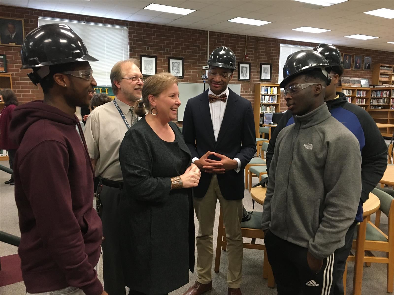 Guilford County board member Winston McGregor and teacher John Hensley talk with students from the Academy at Smith 